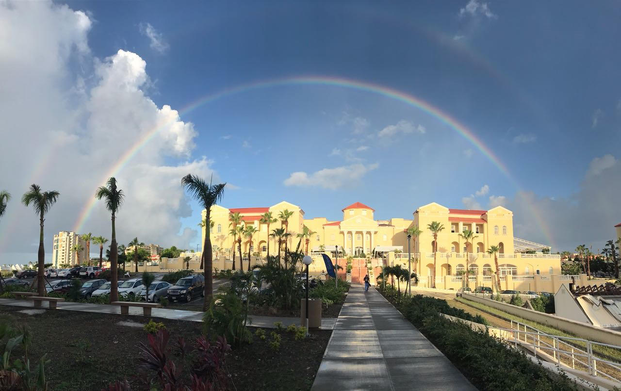 Sunny view of a rainbow over AUC's campus