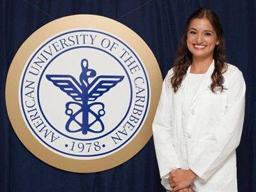 Tiffany Strong standing next to AUC seal 