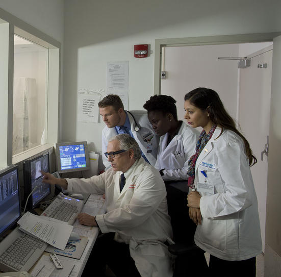 Doctors looking at computer screens 