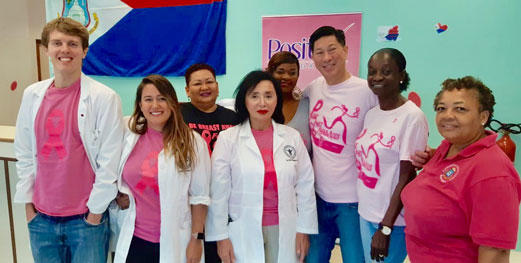 Group of students and faculty wearing breast cancer awareness t-shirts