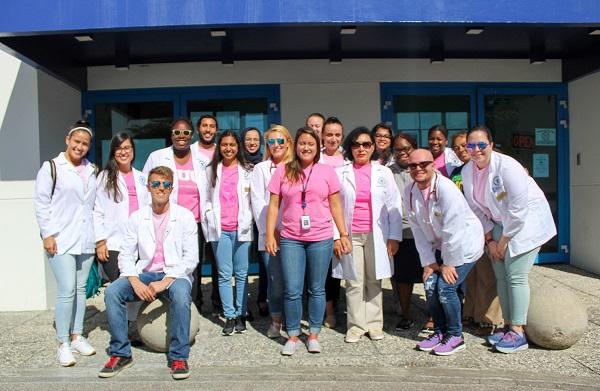Group of students and faculty wearing breast cancer awareness t-shirts