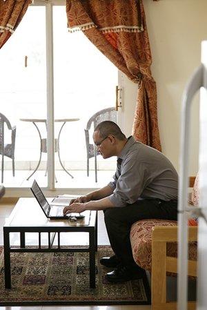 View of man looking on a laptop